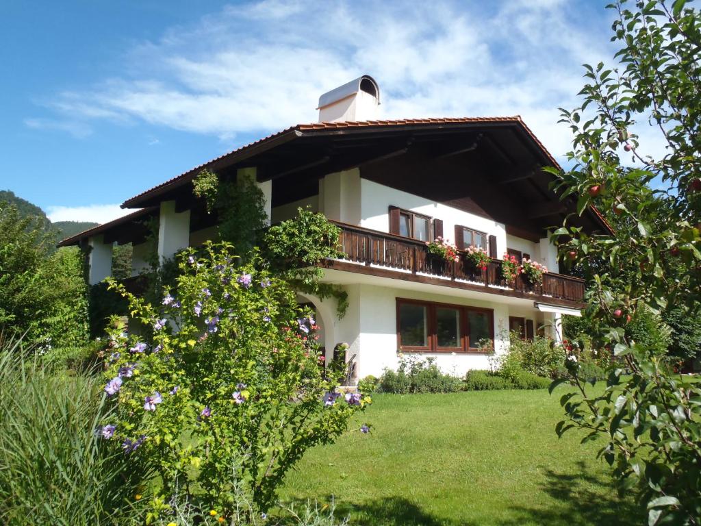 ein Haus mit einem Balkon mit Blumen darauf in der Unterkunft Ferienwohnung Erna Heigermoser in Ruhpolding