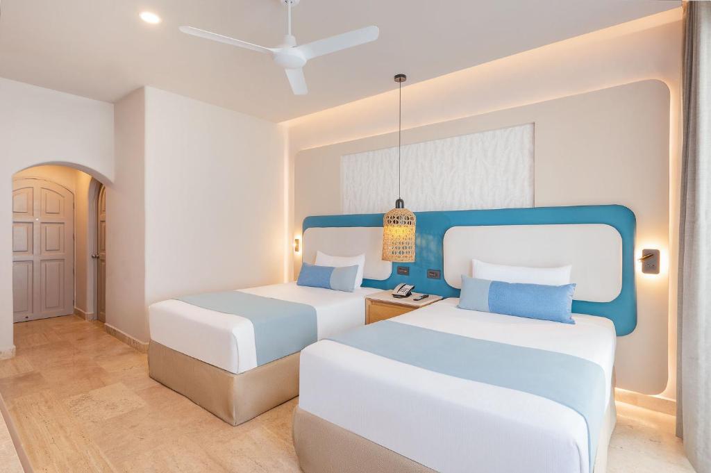 Postel nebo postele na pokoji v ubytování GR Solaris Caribe - All Inclusive
