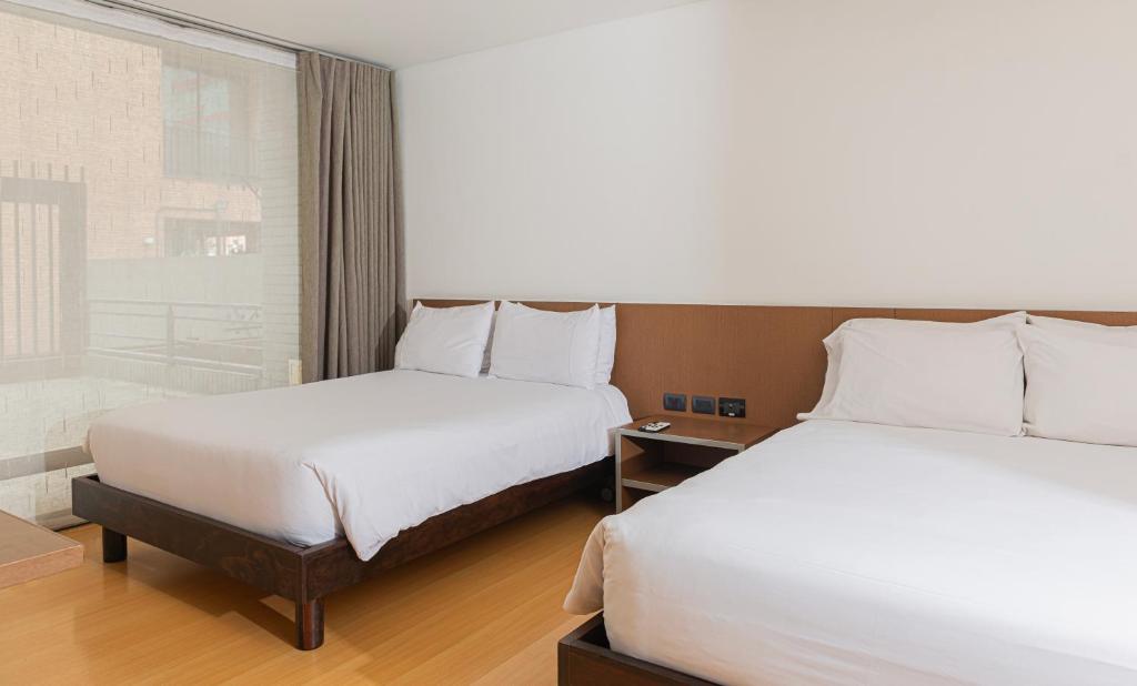 Postel nebo postele na pokoji v ubytování Hotel Viaggio Nueve Tres