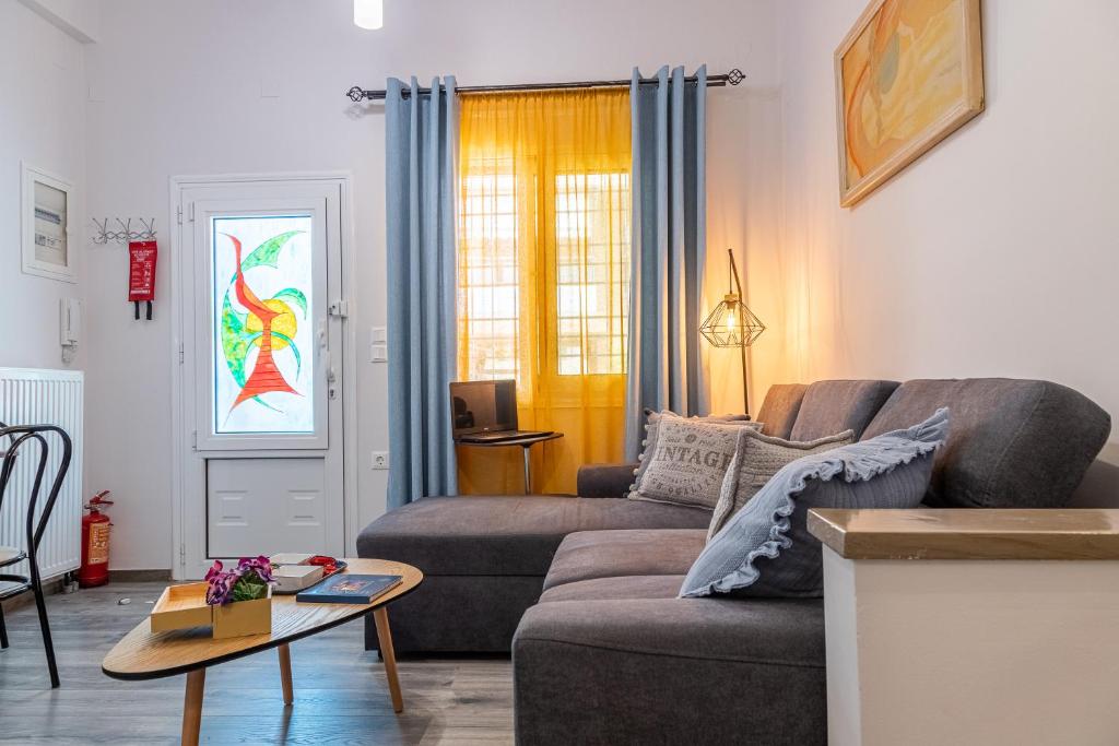 a living room with a couch and a table at Chill Vibes Luxurious Living House in Volos
