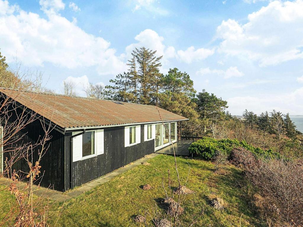 a black and white house on top of a hill at Secluded Beach Retreat - By Traum Ferienwohnungen in Lihme