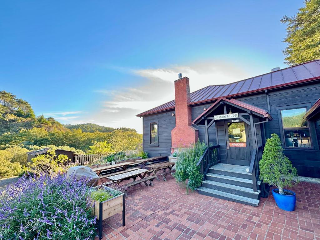 a home with a brick patio and a house at Limantour Lodge in Point Reyes Station