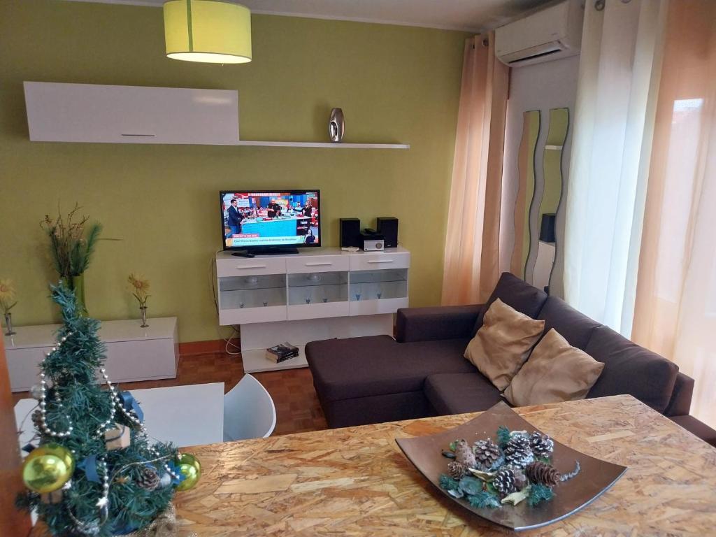 a living room with a christmas tree and a couch at Huge 3 Bedrooms Balcony Flat for 8 pax in Seia