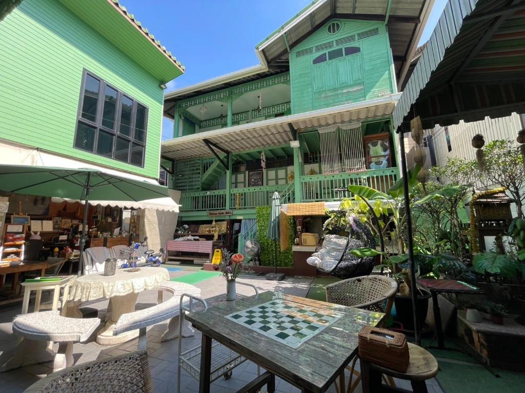 a patio with a table with a chess board on it at Green Teak House in Bangkok