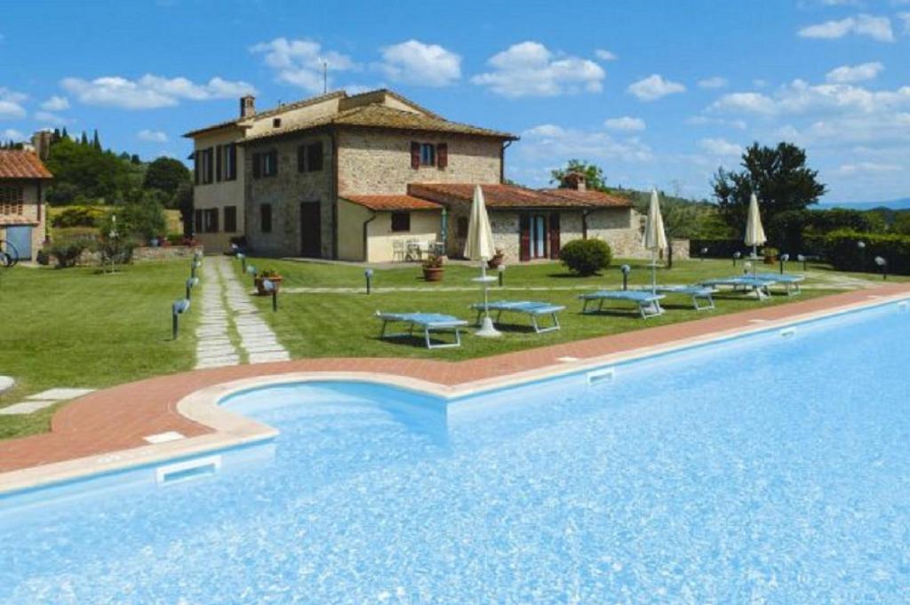 
a house that has a pool in it at Podere Il Gioiello in San Gimignano
