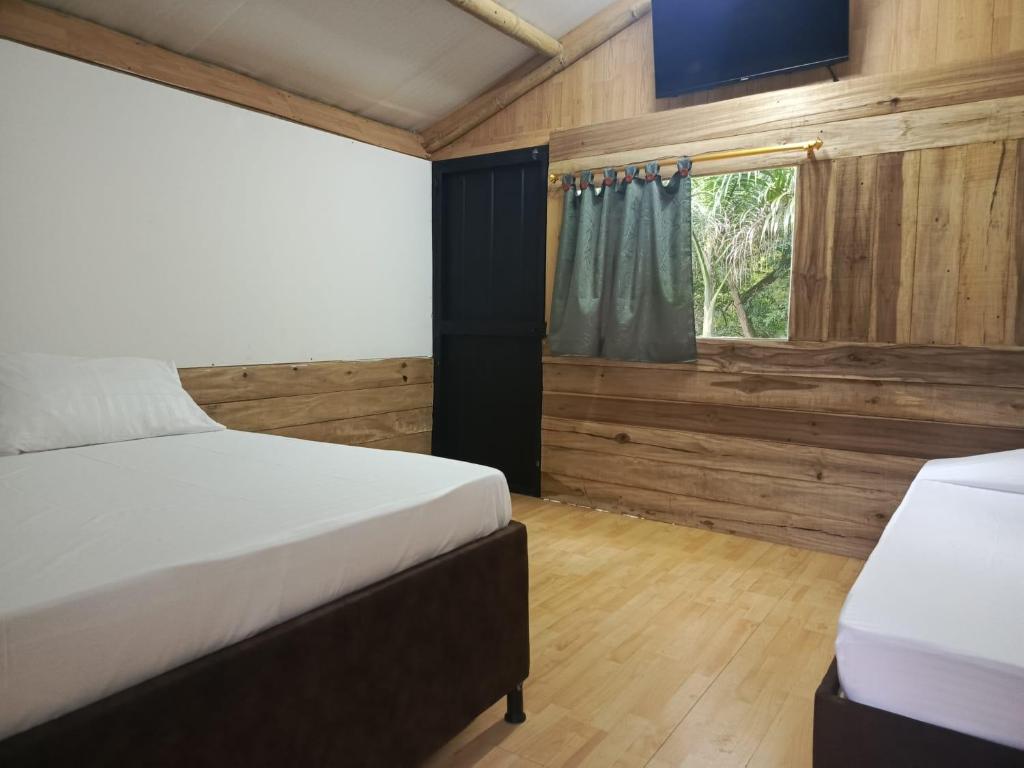 Postel nebo postele na pokoji v ubytování Hotel Hábitat Campestre "cerca al Parque deportivo"