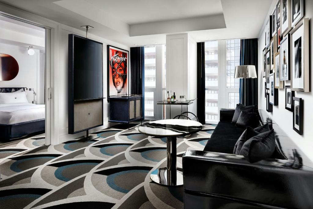 a living room with a couch and a television at BISHA, a Luxury Collection Hotel, Toronto in Toronto