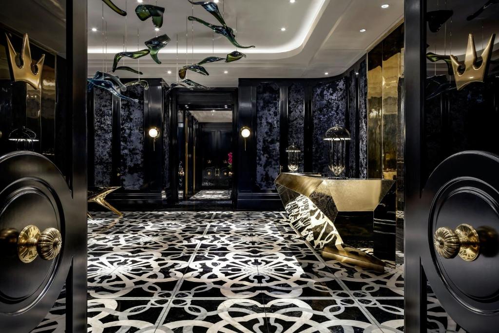 a lobby with a black and white tile floor and a bathroom at BISHA, a Luxury Collection Hotel, Toronto in Toronto