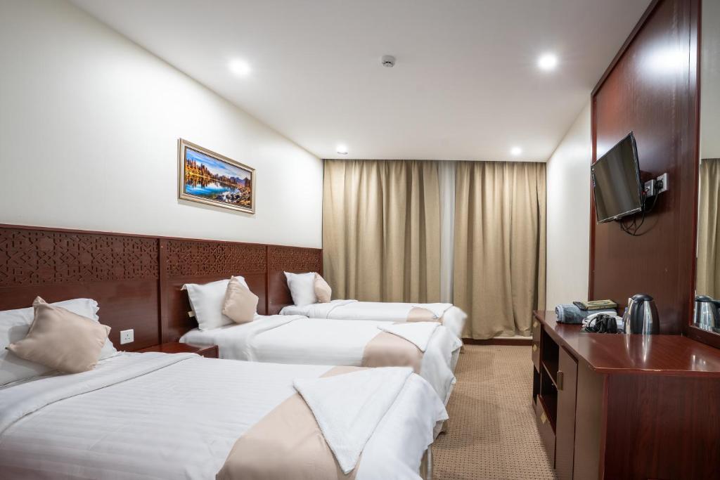 Postel nebo postele na pokoji v ubytování Cordoba Al Azizia Hotel