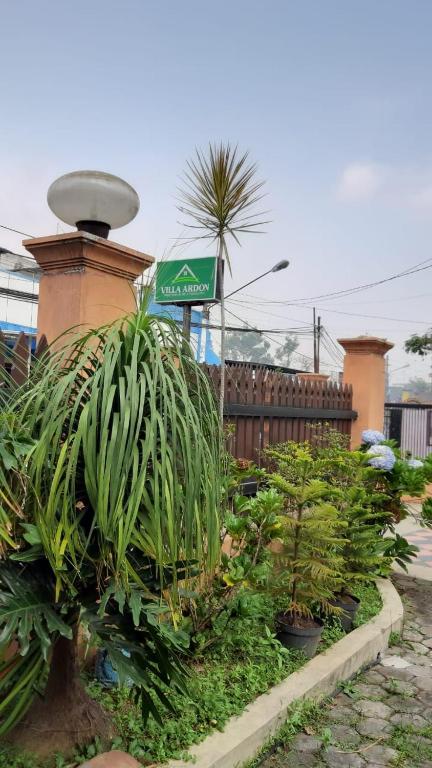 a street sign with plants in a garden at Villa Ardon Batu in Batu