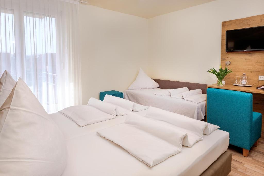 Postel nebo postele na pokoji v ubytování Hotel Mythos