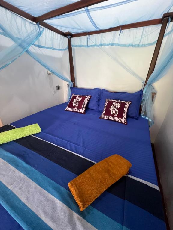 Postel nebo postele na pokoji v ubytování TEMBO Cottage Wilpattu