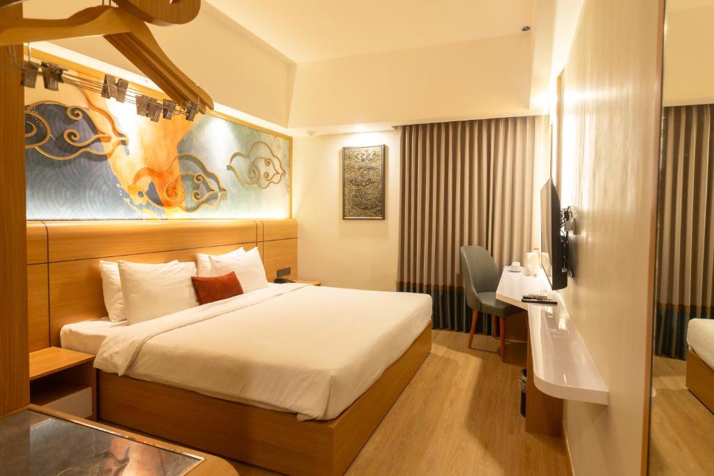 Postel nebo postele na pokoji v ubytování Metland Hotel Cirebon