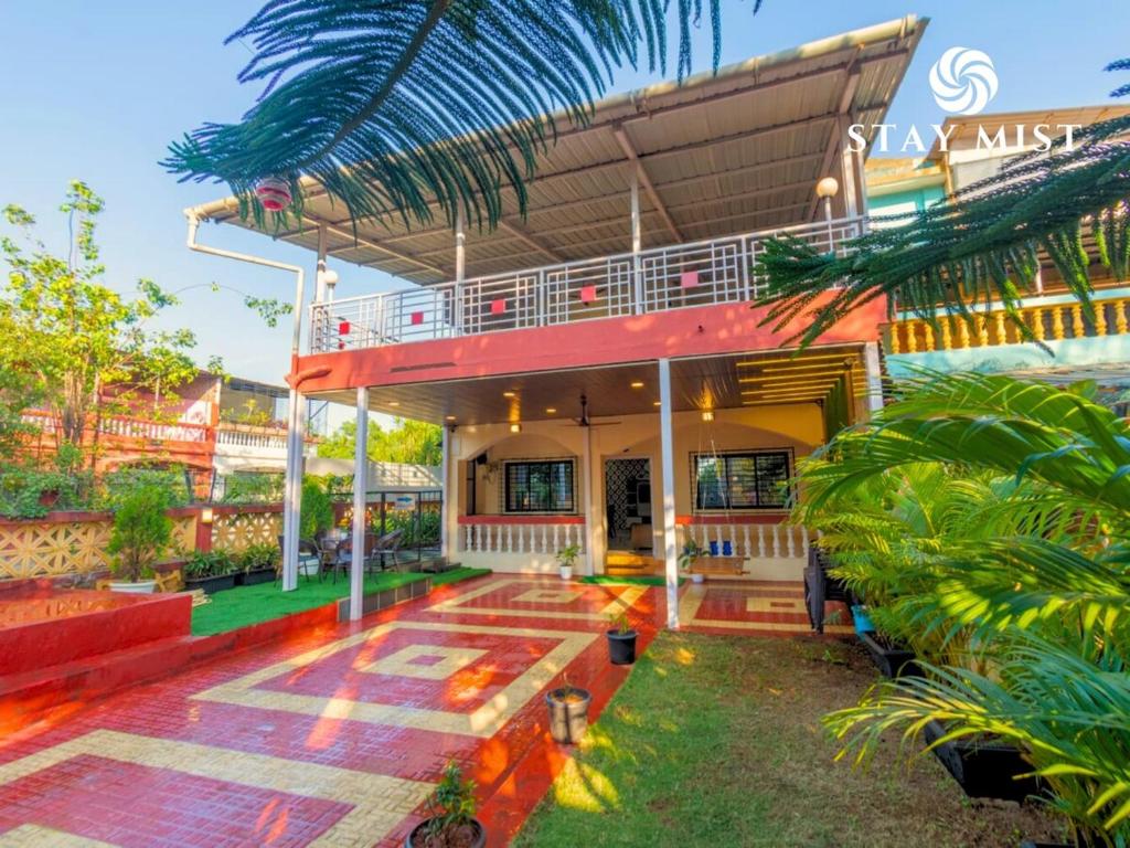 a house with a porch and a balcony at Staymist - Casa Palais in Lonavala