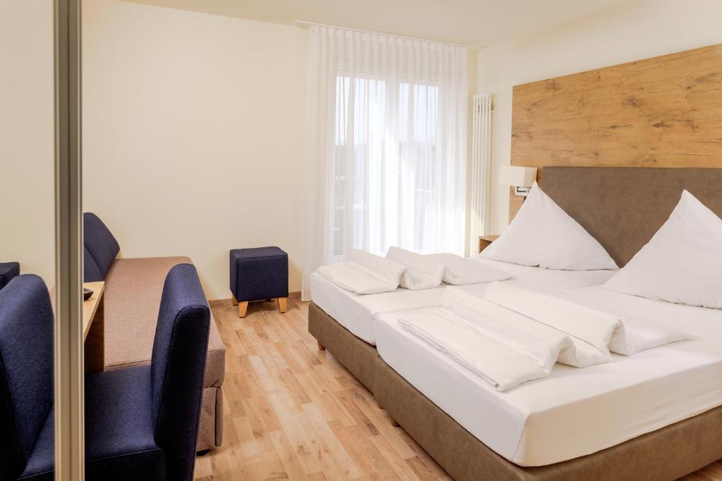 Postel nebo postele na pokoji v ubytování Hotel Mythos
