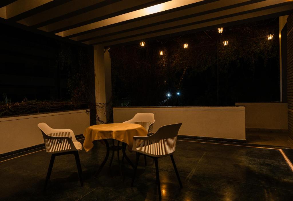 a table and chairs on a patio at night at The Palace Inn - A boutique villa in Jaipur