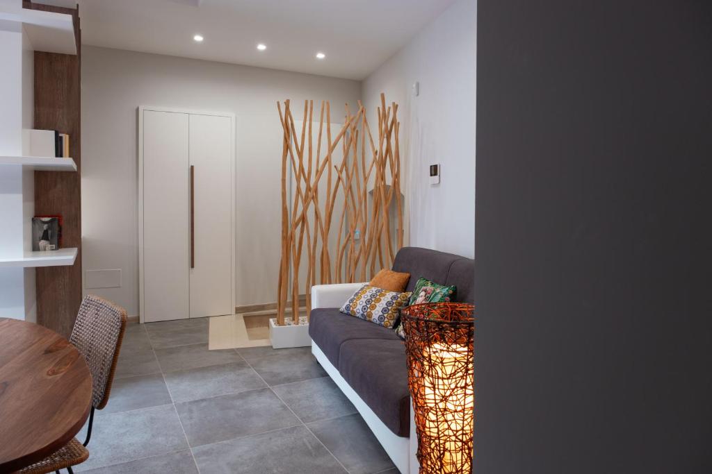 a living room with a couch and a table at Arco Miraglia suite - Apulia Houses & Flats in Ruvo di Puglia