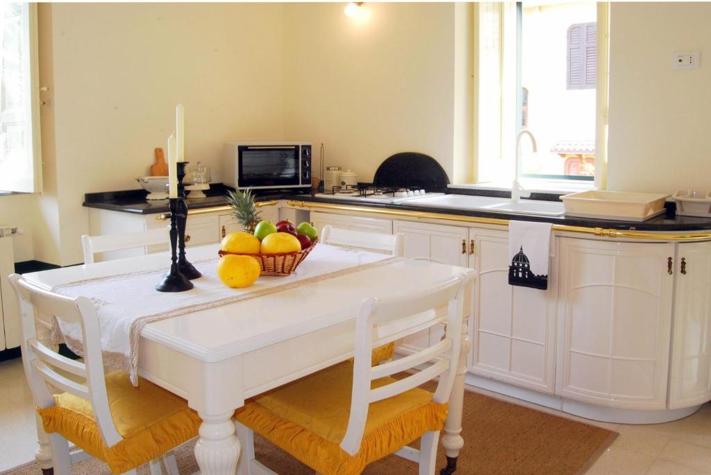 a kitchen with a table with a bowl of fruit on it at Casa Canape in Gioiosa Marea