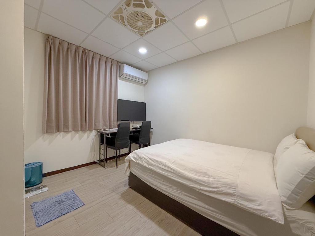 Postel nebo postele na pokoji v ubytování Tamshui Homestay