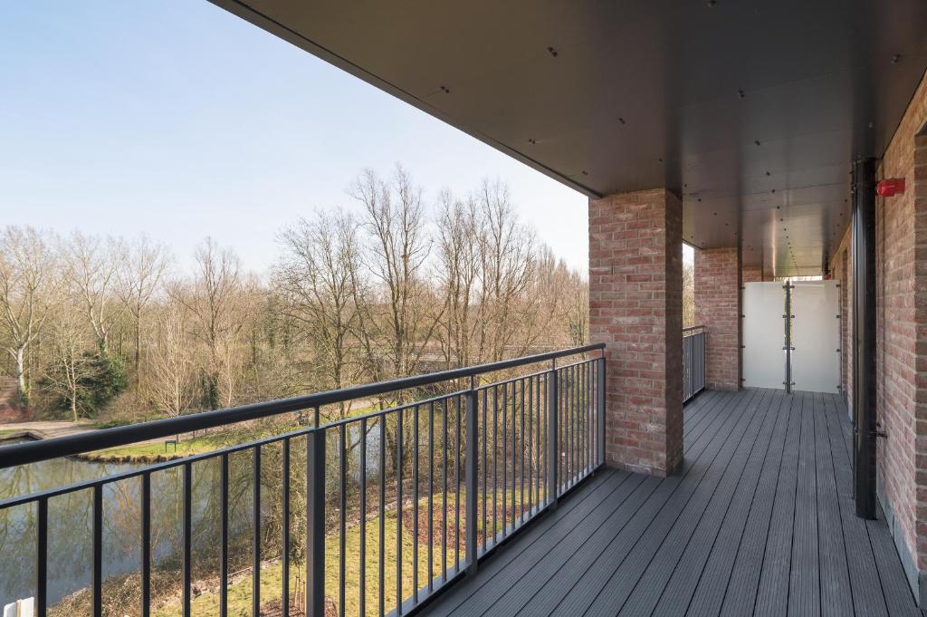 a balcony of a building with a door on it at Lovely Home Near Canal, Park, & Central MK in Milton Keynes
