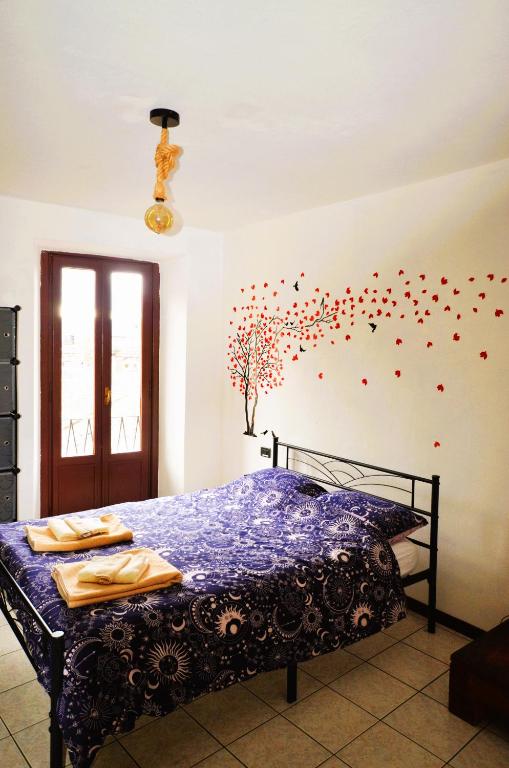 a bedroom with a bed with confetti on the wall at Casa Ginny in Orta San Giulio