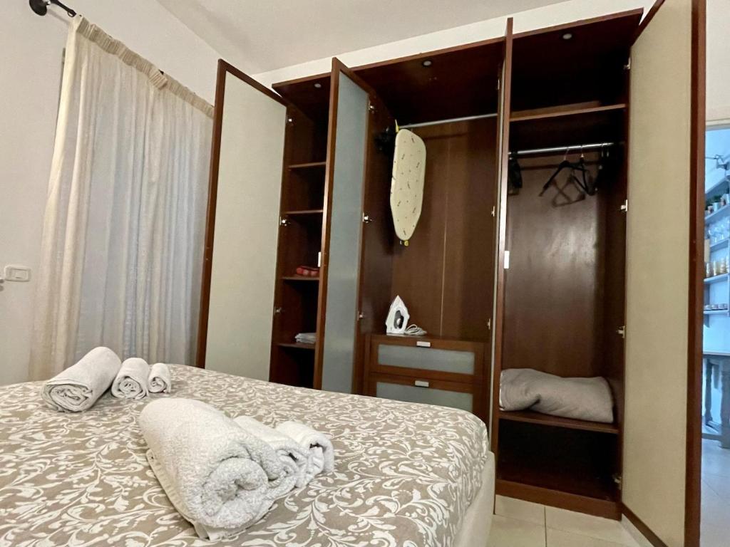a bedroom with a bed with towels on it at Giardino della Bassa in Marina di Carrara