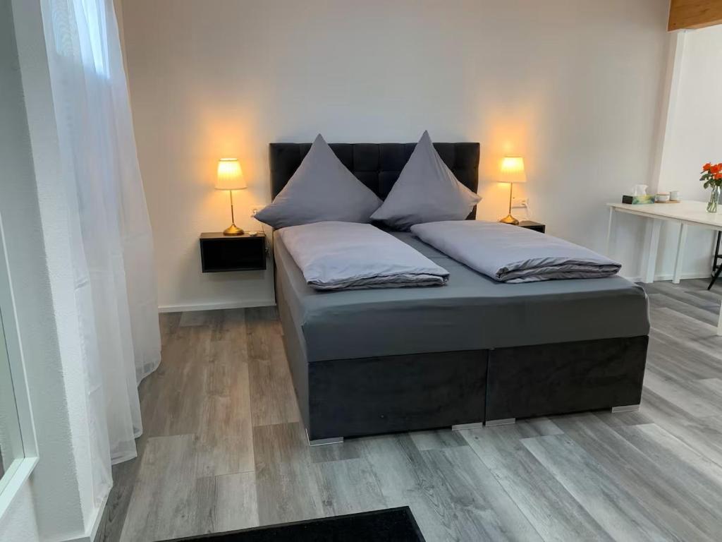 a bed with two pillows on it in a room at Luxus Appartement Motel Ambiente 2 in Bad Säckingen