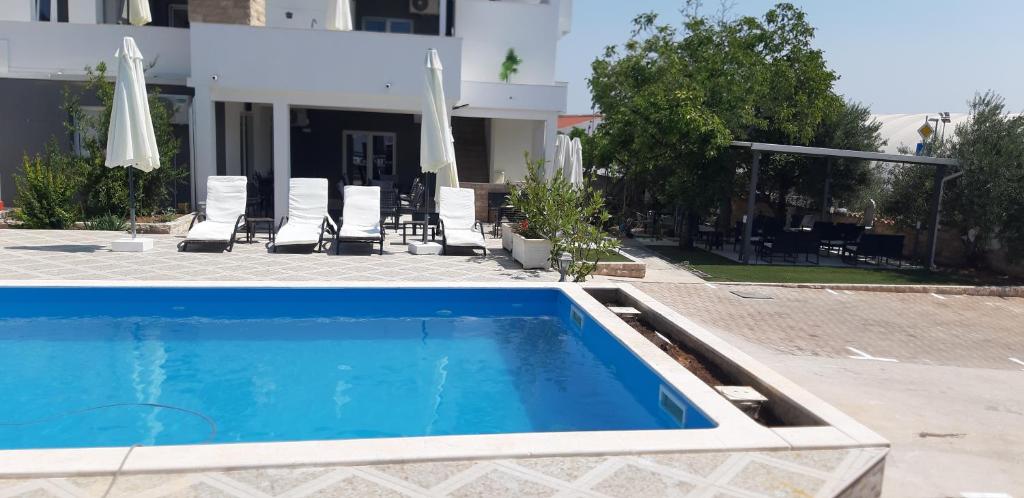 a swimming pool in front of a house at Holiday home Vodice in Vodice