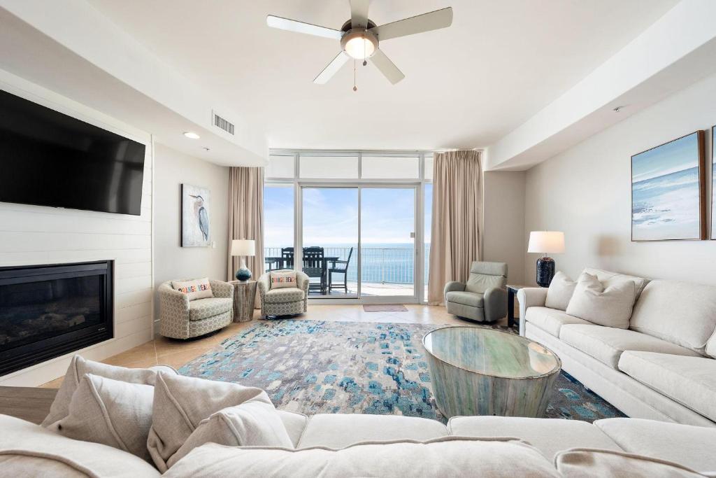 a living room with a couch and a fireplace at Turquoise D1306 in Orange Beach