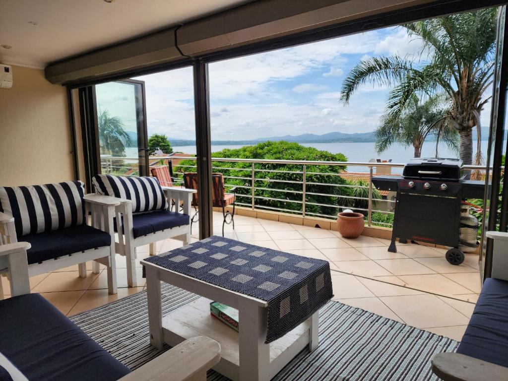 a screened in porch with a view of the ocean at BondMakers Hidden Gem in Hartbeespoort