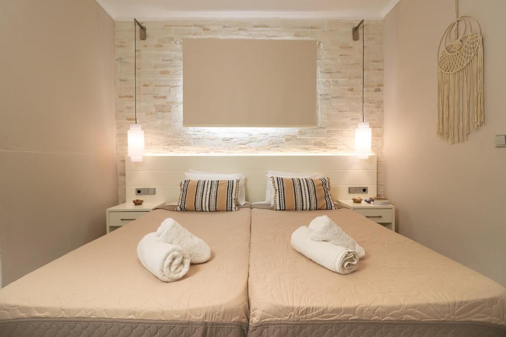 a bedroom with a bed with two white pillows at Andreas Hideaway Palaiokastritsa in Paleokastritsa