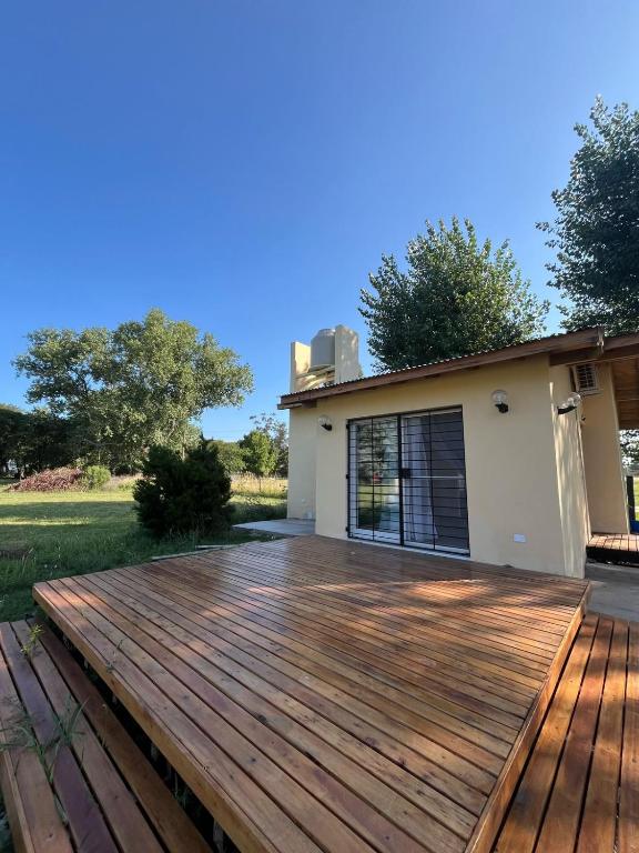 a wooden deck in front of a house at Casita Amarilla in Miramar