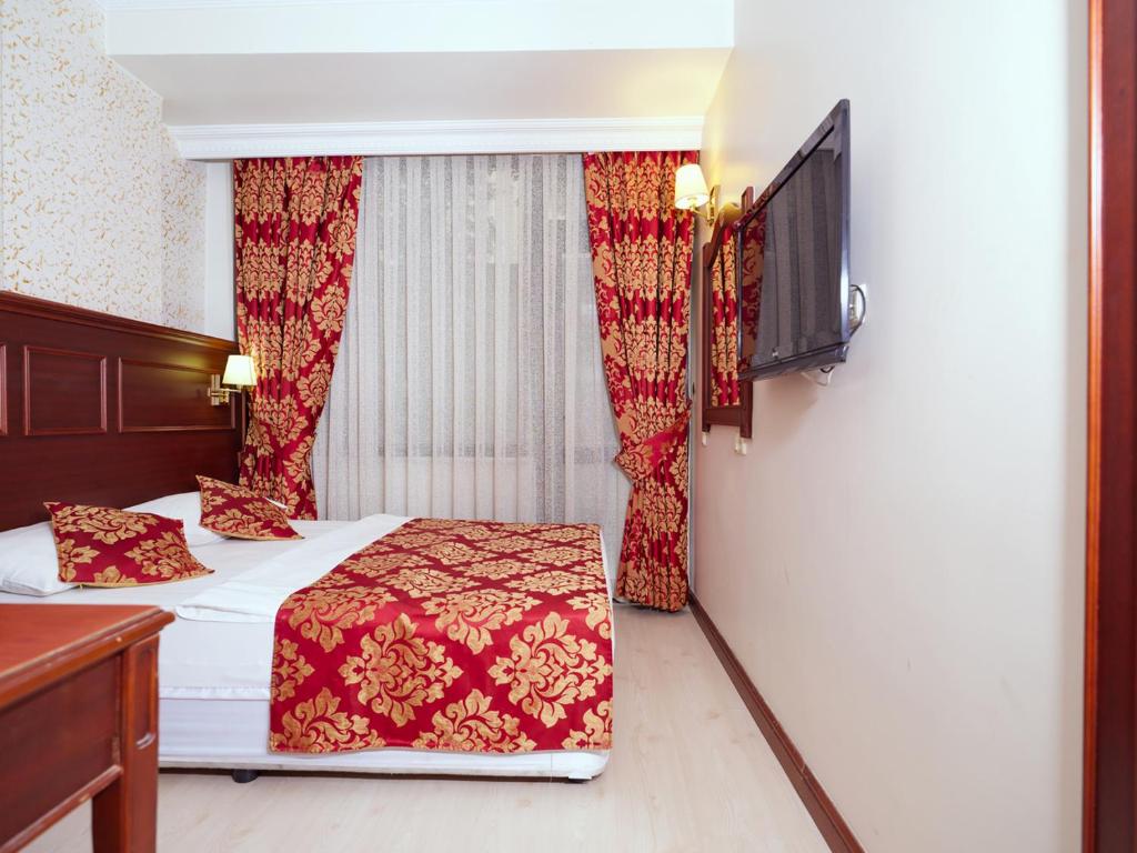 a hotel room with two beds and a window at Istanbul Newcity Hotel in Istanbul
