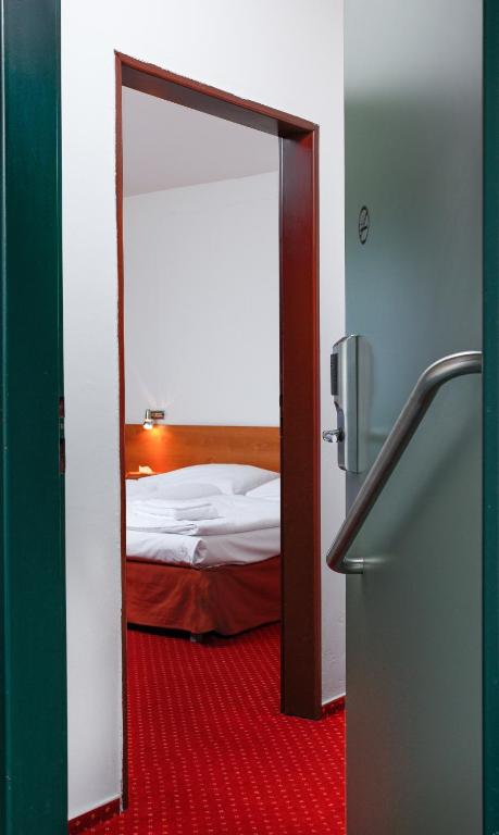 Postel nebo postele na pokoji v ubytování Hotel Globus