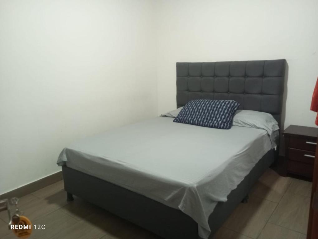 a bedroom with a large bed with a black headboard at Hotel Talauta Resort in Talauta
