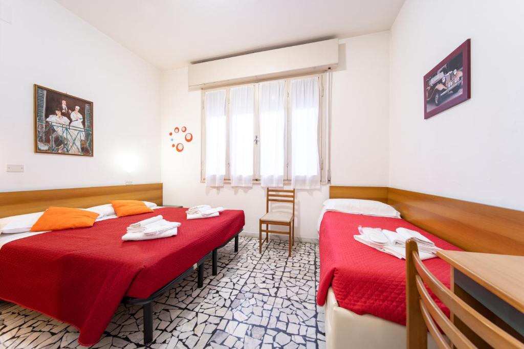 Postel nebo postele na pokoji v ubytování Hotel Cortina