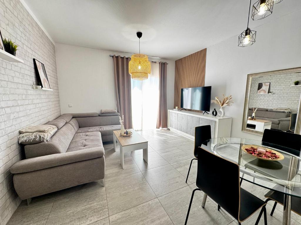 a living room with a couch and a table at Starfish Home in Costa Del Silencio