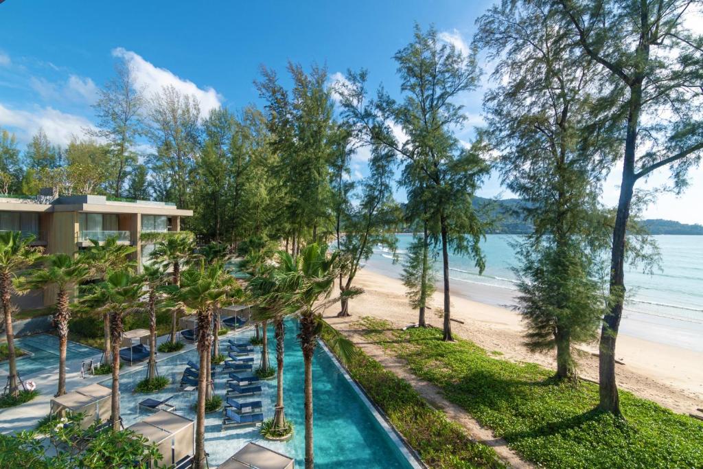 a view of the beach from the balcony of a resort at Luxury Penthouse 407sqm Beachfront and private pool in Phuket Town