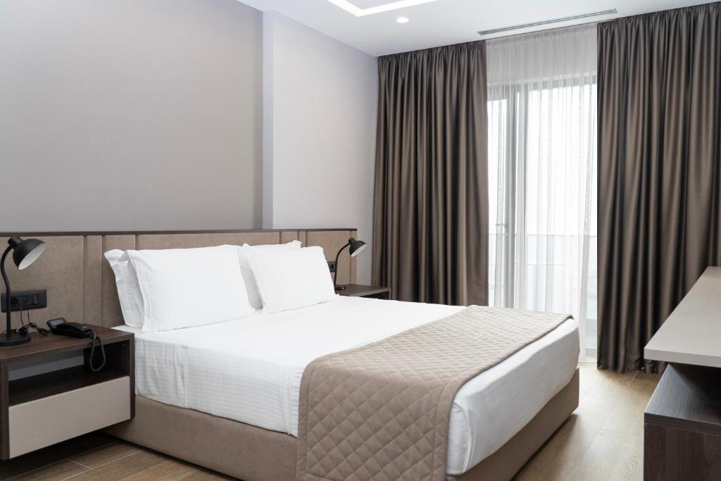 Postel nebo postele na pokoji v ubytování Joelle Premium Hotel