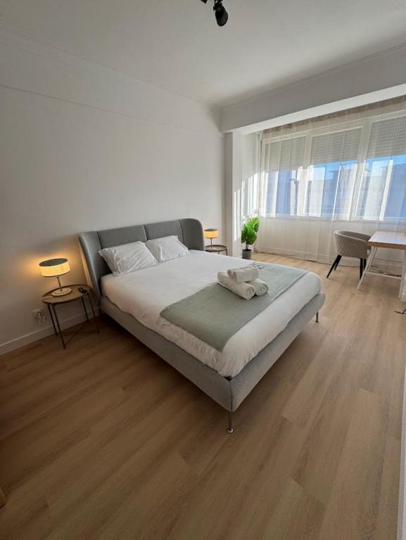 a bedroom with a large bed in a room at The Crow Ajuda Apartment I in Lisbon