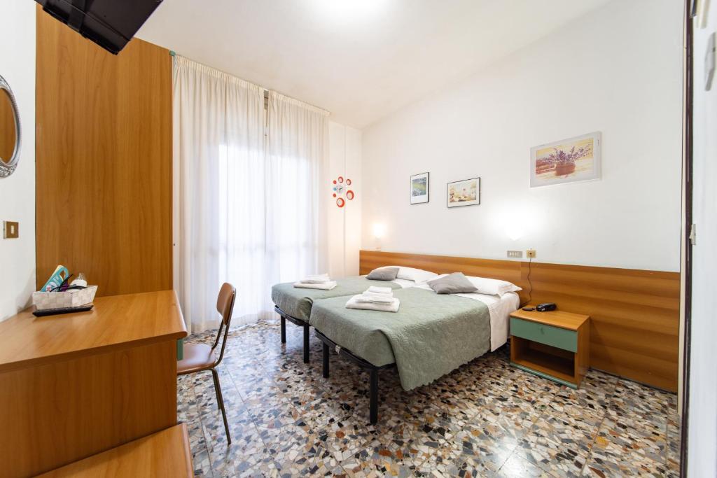 Postel nebo postele na pokoji v ubytování Hotel Cortina