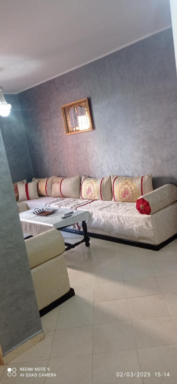 a living room with a couch and a table at Riyad biougra in Biougra