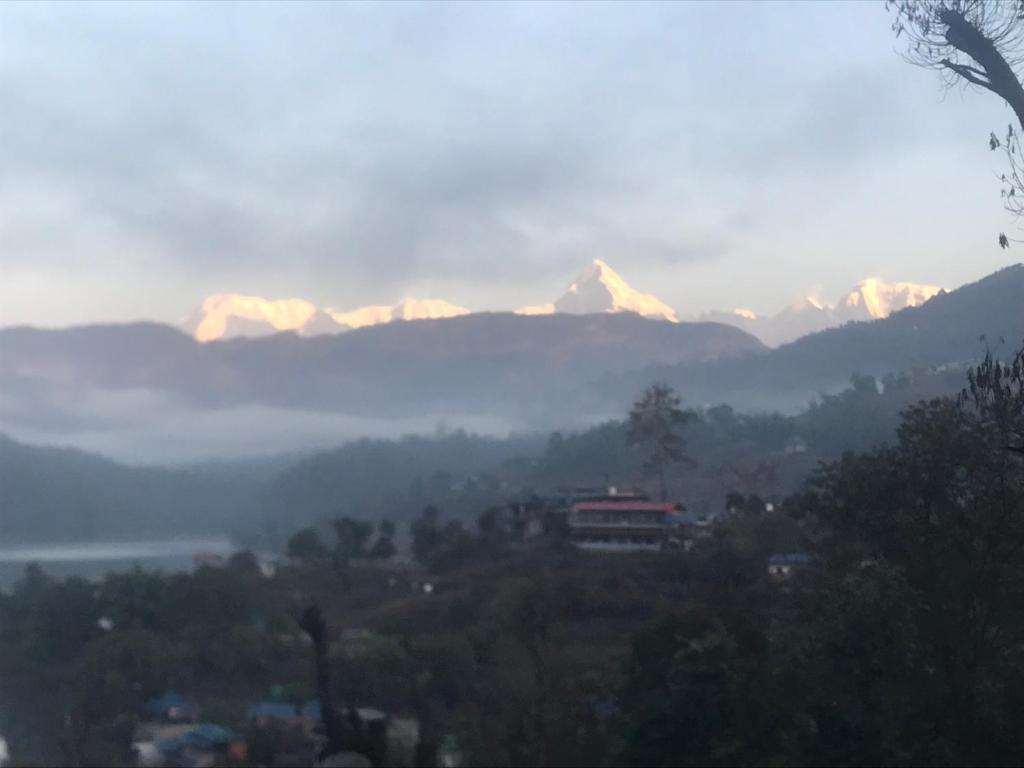 a view of a mountain range with mountains in the background at Little Heaven Restaurant &guest House in Deorāli