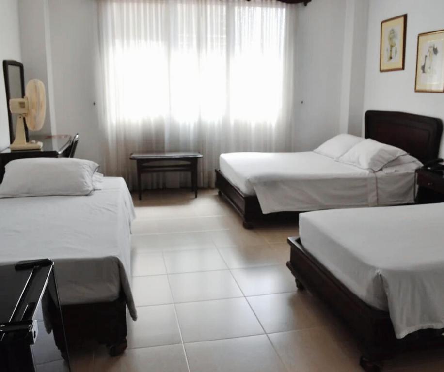 Postel nebo postele na pokoji v ubytování Gran Hotel