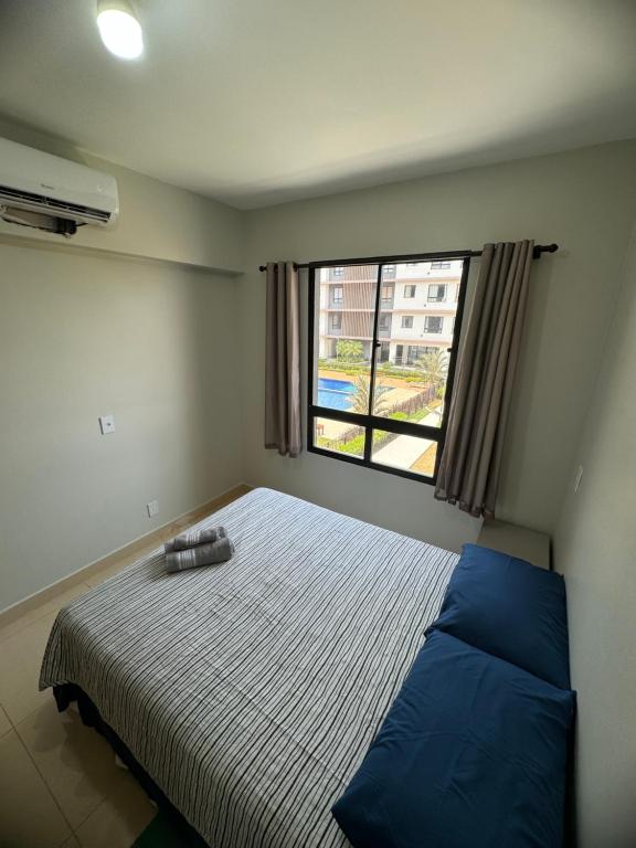 a bedroom with a bed and a large window at Apto 202, Torre 1 in Lucas do Rio Verde