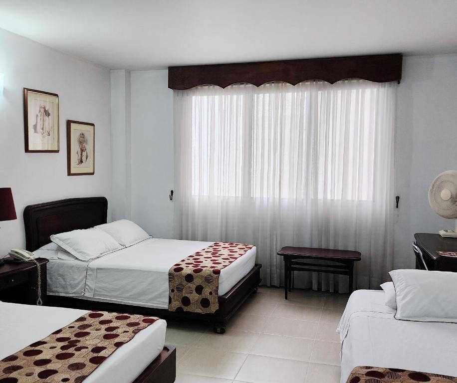 Postel nebo postele na pokoji v ubytování Gran Hotel