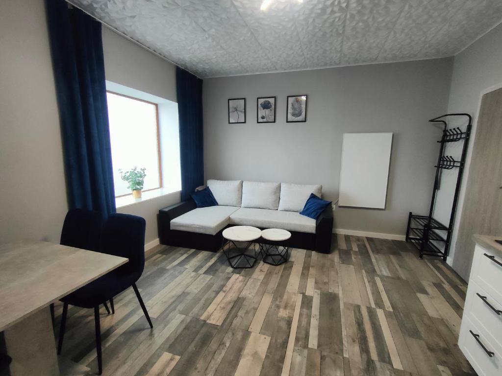 a living room with a couch and a table at 722 Slate Apartament Jedlina-Zdrój in Jedlina-Zdrój