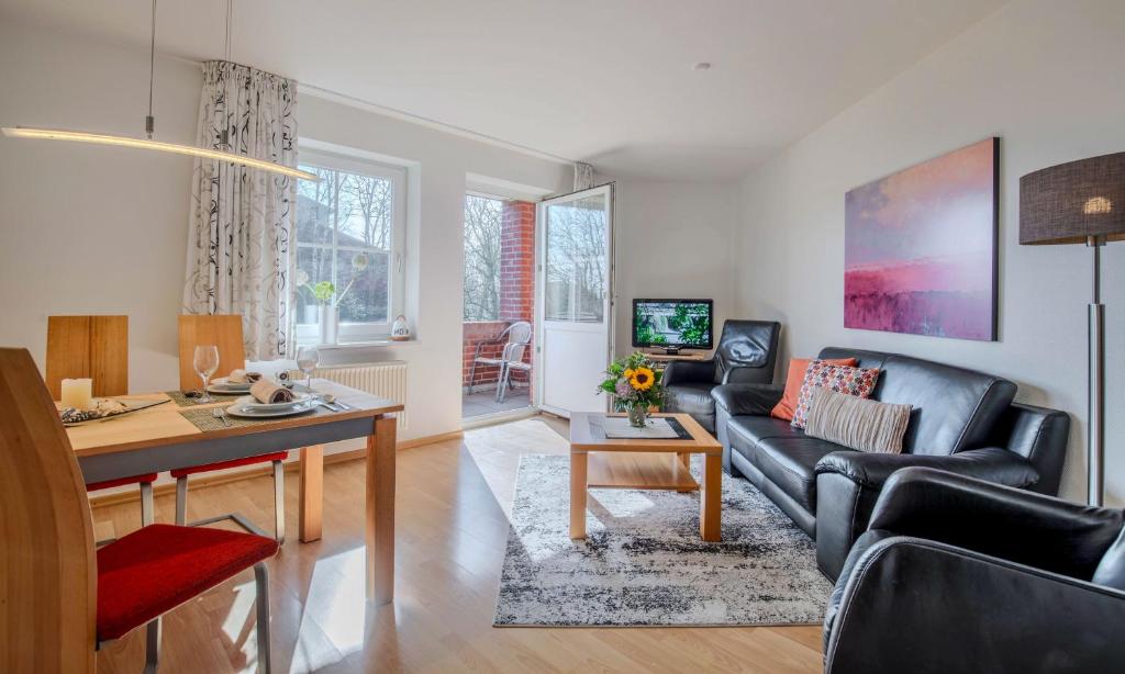 a living room with a couch and a table at "Landhaus Voss" Typ 3 Nr9 in Staberdorf