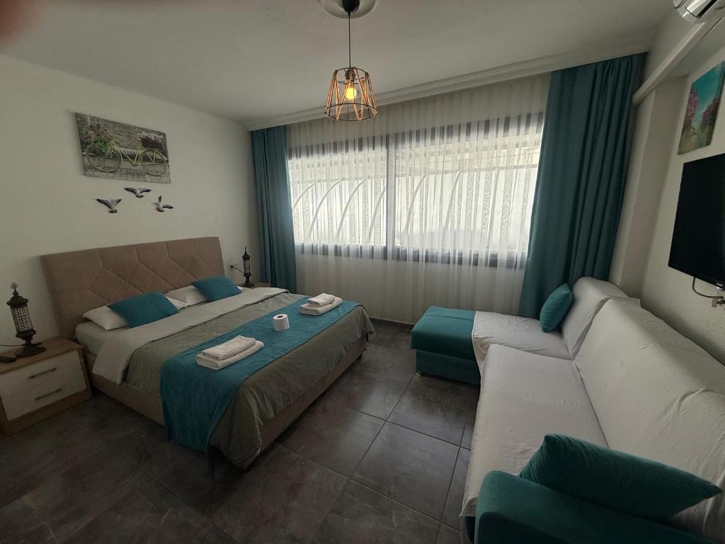 a hotel room with a bed and a couch at Arslan Homes 2 in Marmaris