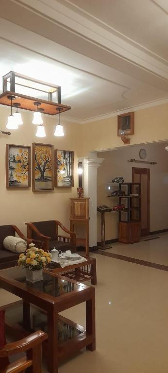 a living room with a table and a couch at Kusum villa in Imaduwa